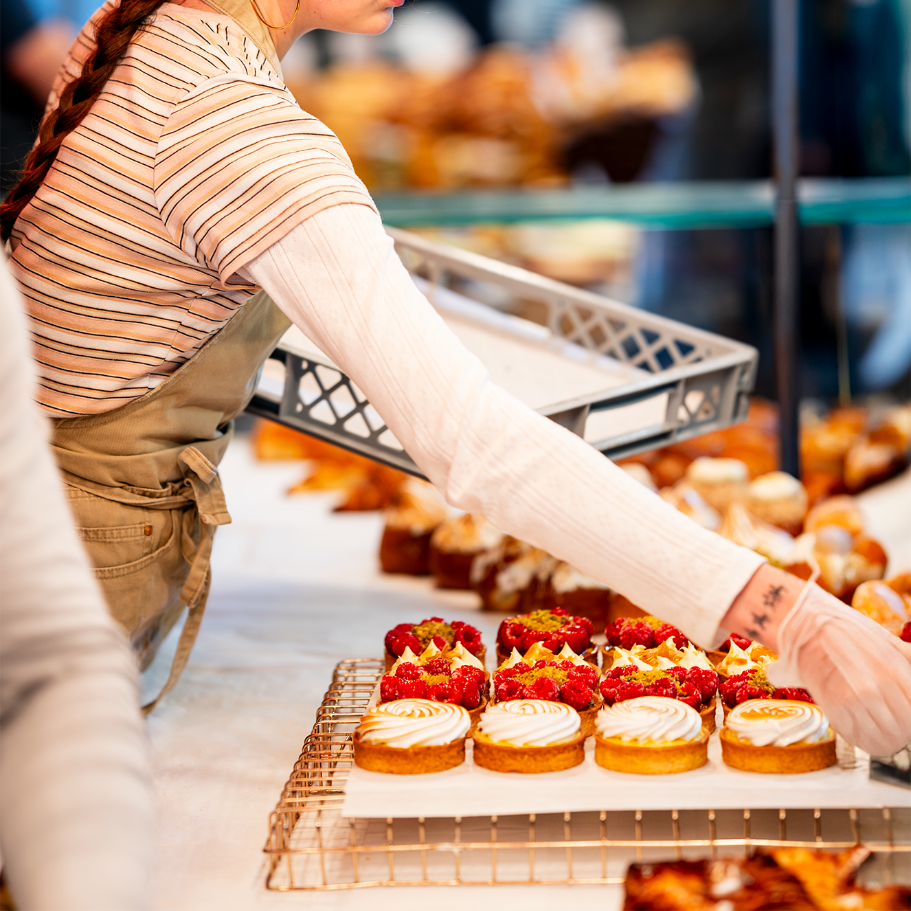 Trader laying out pastries at the market stall